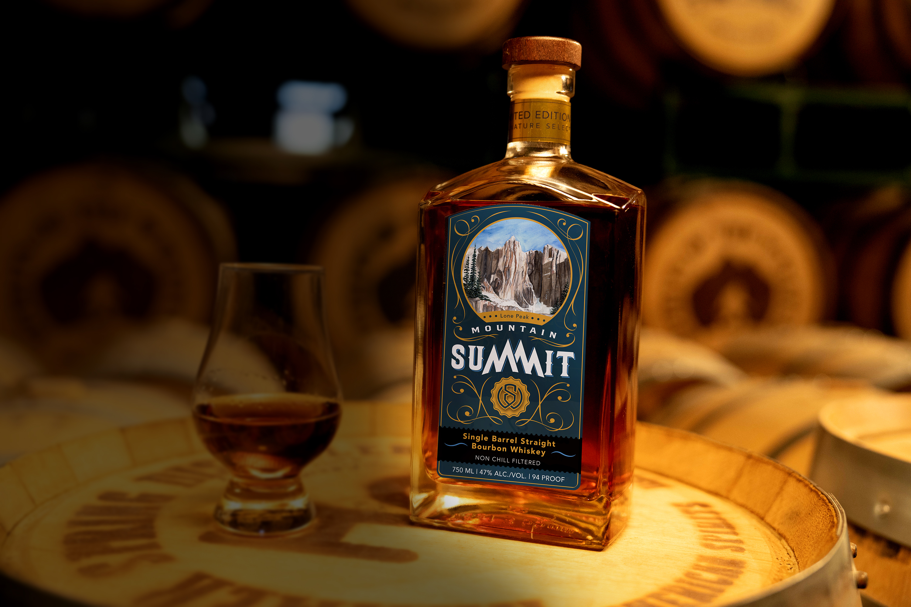 Mountain Summit: Single Barrel Bourbon Whiskey Bottle - Professionally photographed. Sitting atop an aging barrel.